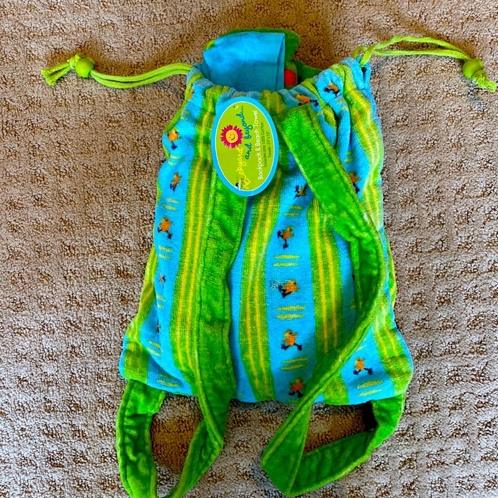 Brand new. Super cute towel with matching backpack for towel.